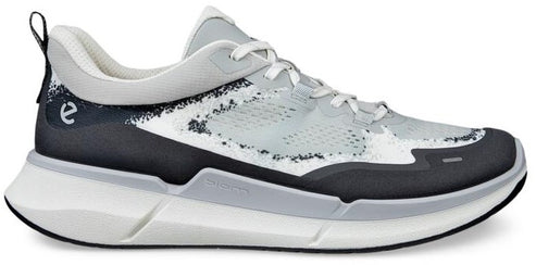 A gray, white, and black running shoe with a thick sole.