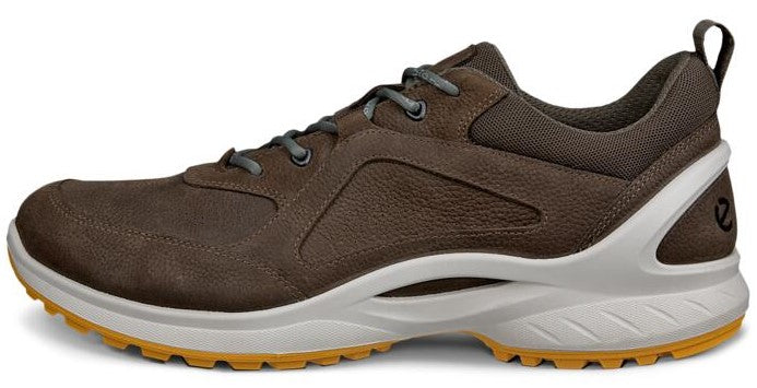 A brown walking shoe with a white sole and gray laces.