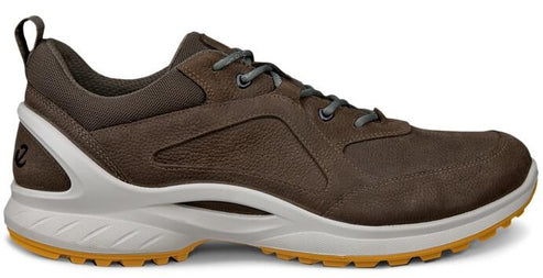 A brown hiking shoe with a white sole and yellow treads.