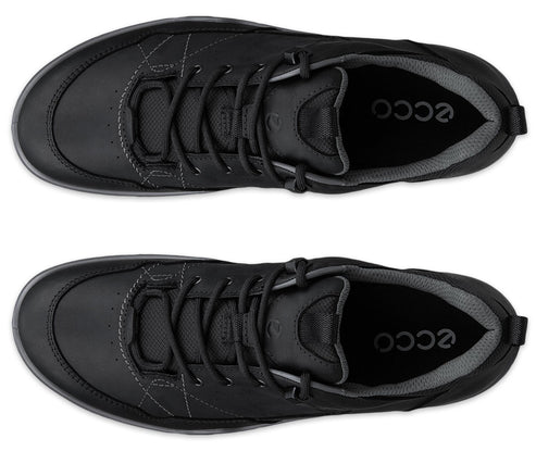 A pair of black, lace-up casual athletic shoes shown from a top-down perspective, featuring a rounded toe, subtle grey stitching details, dark grey mesh lining at the collar, and the brand name printed in white on the interior heel bed.