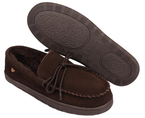 A pair of brown moccasin slippers, one laid on its side showing the sole and a tie closure, the other upright.
