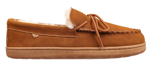A moccasin slipper in brown suede with faux fur lining and a brown sole.