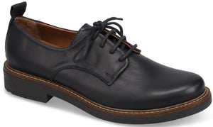 A black leather derby shoe with a rounded toe, five-eyelet lace-up closure, a pull tab at the heel, a light brown welt with contrast stitching, and a low, dark rubber sole.