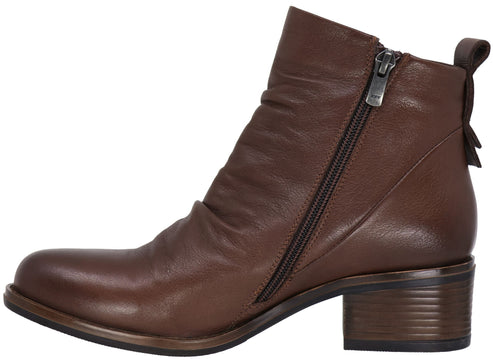 A brown leather ankle boot with a side zipper closure, a low stacked block heel, and a pull tab at the heel collar.