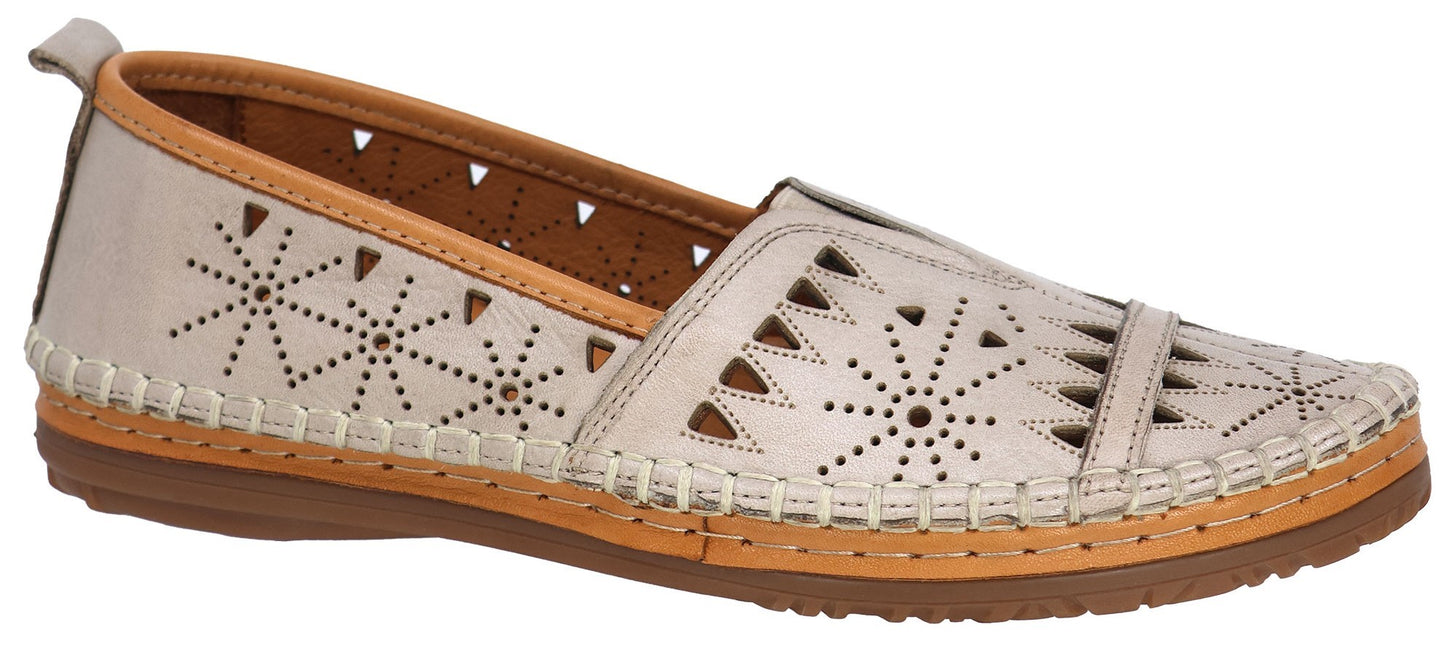Beige slip-on shoe with a pattern of cutouts and decorative stitching.
