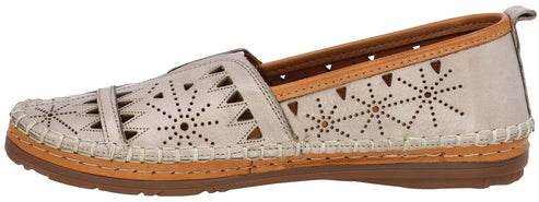 A cream-colored casual slip-on shoe with decorative cutouts and contrast stitching.
