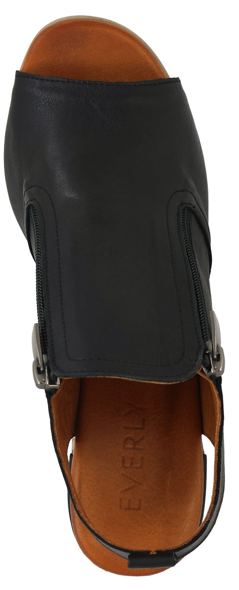 A top-down view shows a black, leather sandal with two silver buckles.