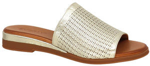 A gold, perforated sandal with a flat heel.