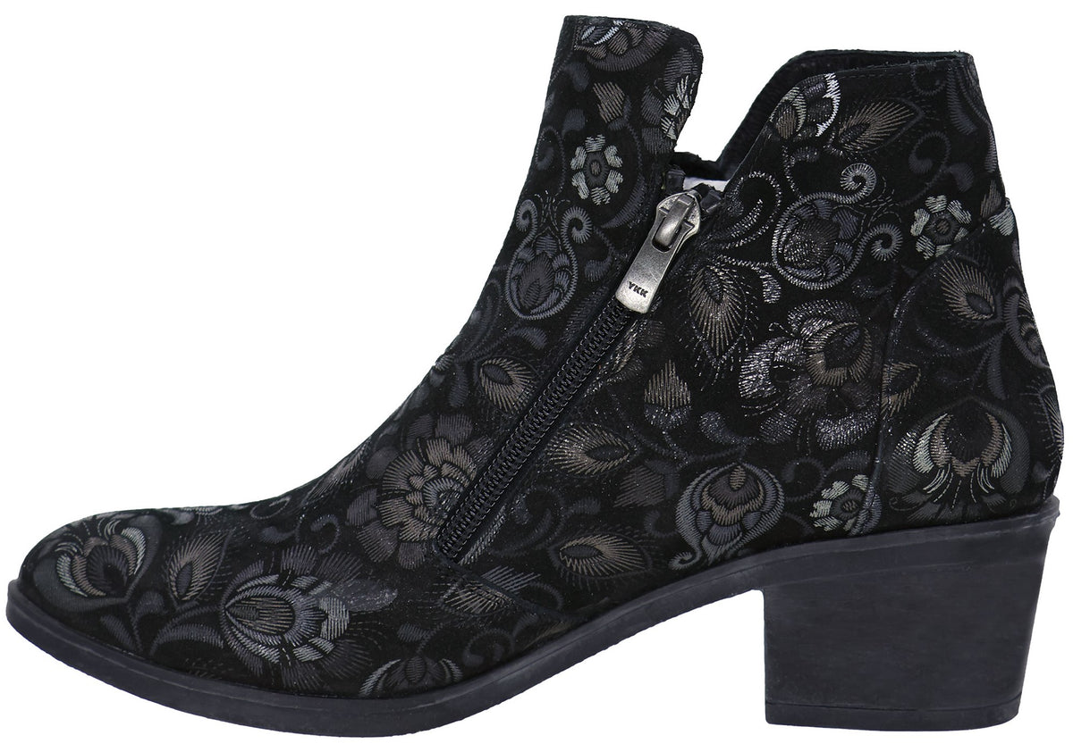 A black ankle boot with a low block heel and a silver floral pattern, featuring a side zipper closure.