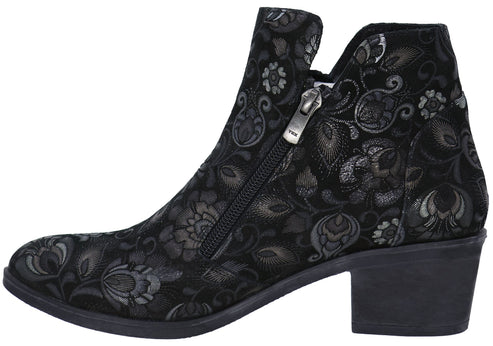 A black ankle boot with a low block heel and a silver floral pattern, featuring a side zipper closure.