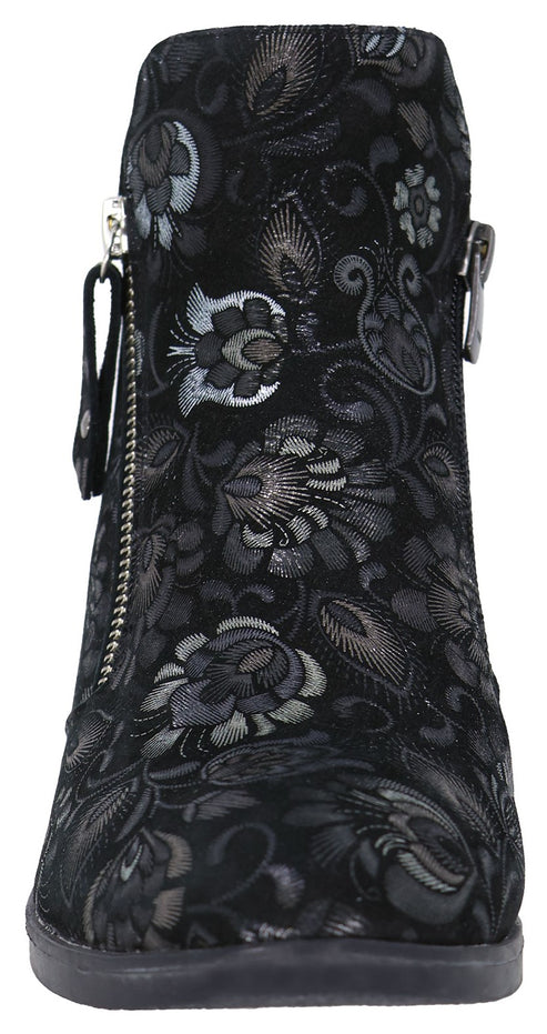 A black ankle boot features an intricate, embroidered floral pattern in silver and dark gray tones, with a side zipper detail.