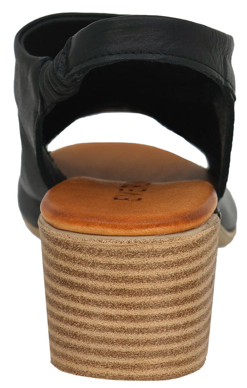 Back view of a black leather sandal with a rounded, tan block heel.