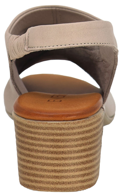 Rear view of a women's beige sandal with a thick stacked heel and a slingback strap.