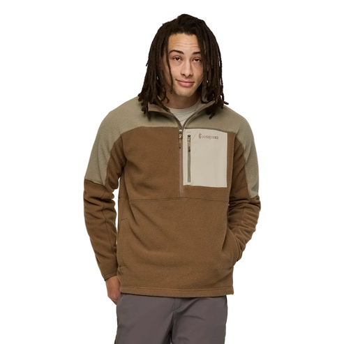 A man wearing a brown and beige long sleeve 1/4 zip shirt with a front pocket.