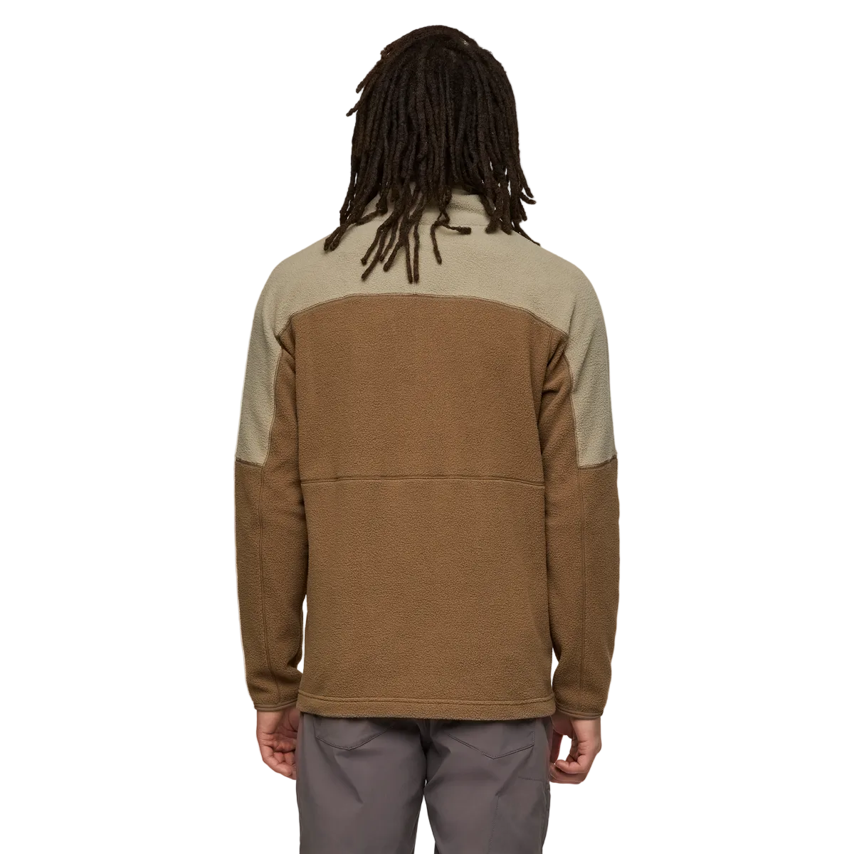 Person from the back wearing brown and beige paneled jacket.
