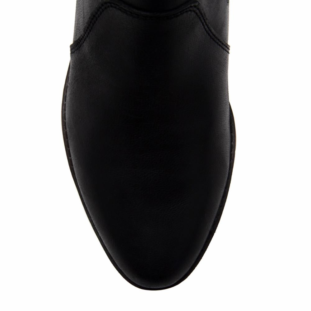 Close-up of a pointed, black boot.
