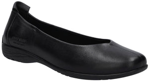 A black leather slip-on ballet flat shoe with a low, flat heel and a seamless, rounded toe design viewed from a side angle.