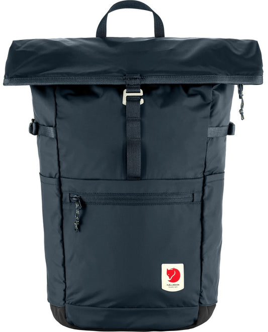 Rolled top backpack, dark blue, with a handle, a front zipper pocket, a red square logo at the bottom right.