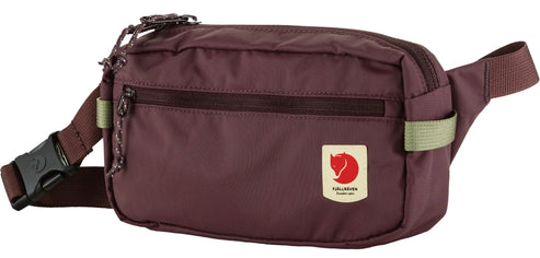 A maroon fanny pack with an adjustable strap and buckle.