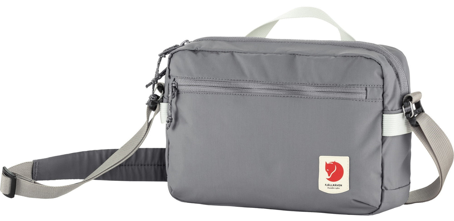 Gray Fjallraven bag with shoulder strap and top handle.