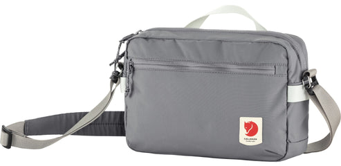 Gray Fjallraven bag with shoulder strap and top handle.