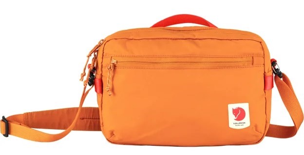 Orange Fjallraven bag with carrying handle and adjustable shoulder strap. Features include a front zipper pocket and logo patch.