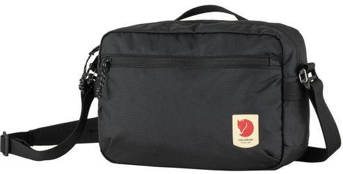 Black rectangular crossbody bag with top handle, zipper pocket, and red and white logo.