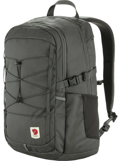 Grey backpack with black bungee cords and a logo patch.