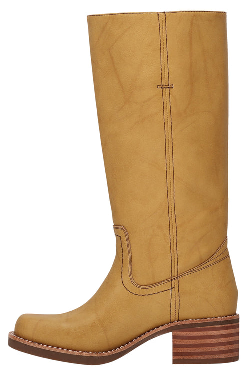 Knee-high yellow leather boot with low block heel and brown stitching.