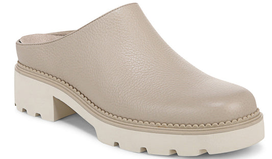 A beige leather clog with a white chunky lug sole and block heel.