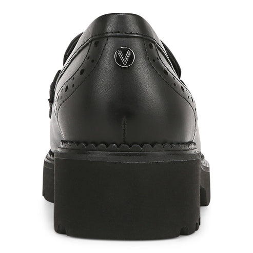 Back view of a black leather platform Mary Jane with a buckle strap and decorative perforations.