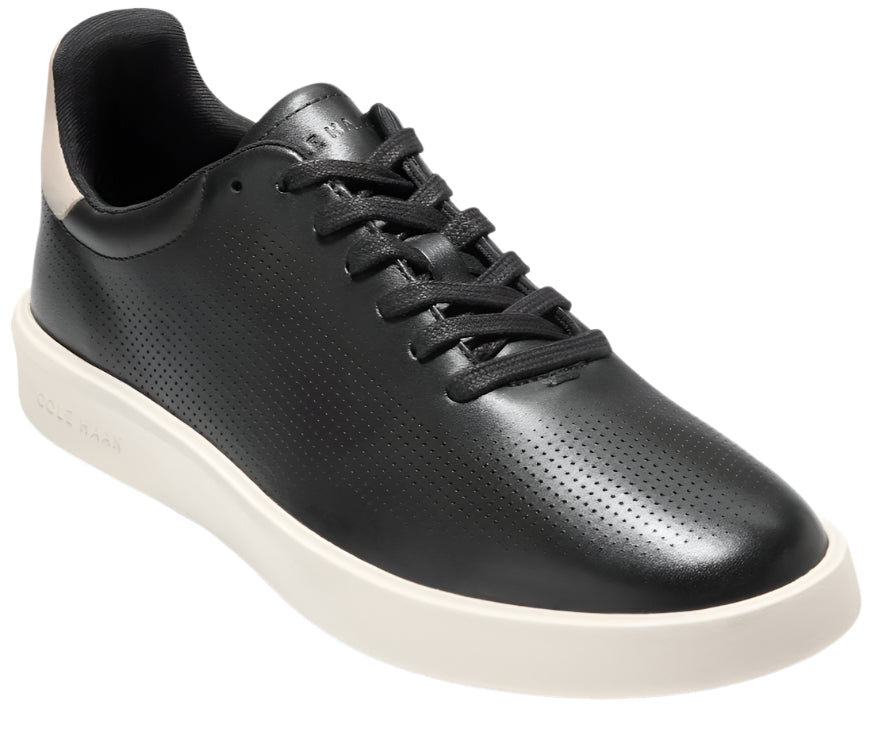 Black leather low-top sneaker with perforations, white sole and black laces.
