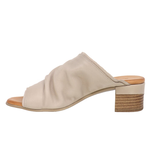 Beige mule sandal with a ruched upper and block heel.