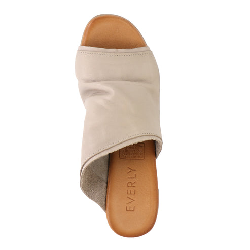 Top-down view of a tan-colored mule sandal with a wide leather strap over the toes and an open back, sole reads EVERLY.