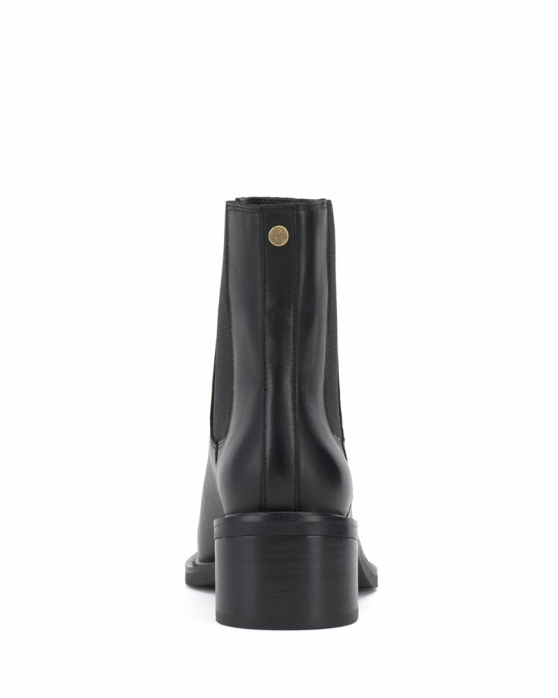 Black ankle boot with elastic side panels and a stacked heel, rear view.