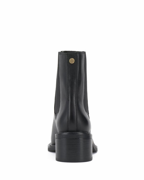 Black ankle boot with elastic side panels and a stacked heel, rear view.