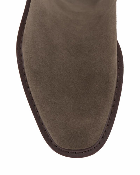 Close-up of the toe of a light-brown suede boot with a square toe.
