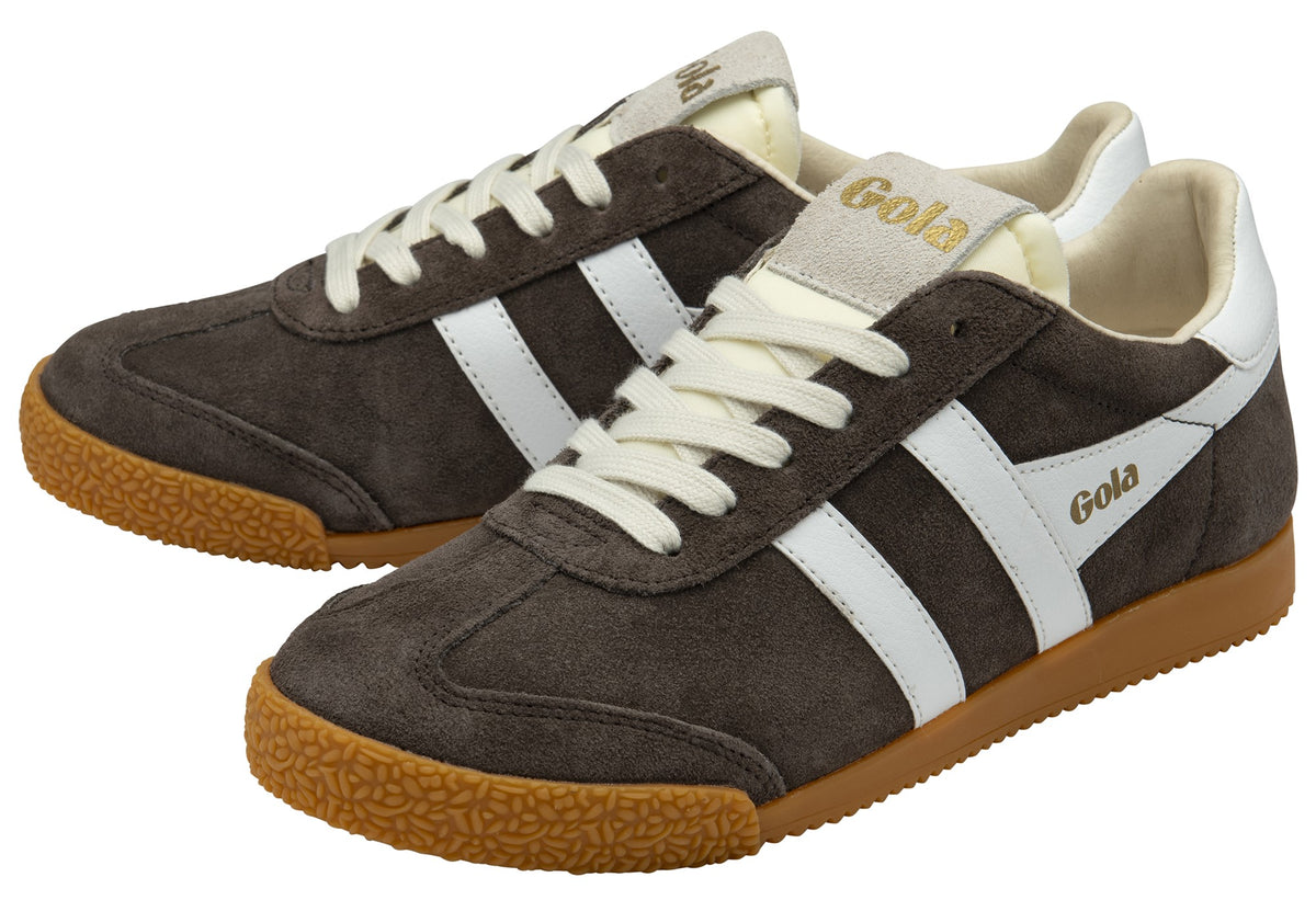 Pair of brown suede sneakers with white stripes and beige laces.