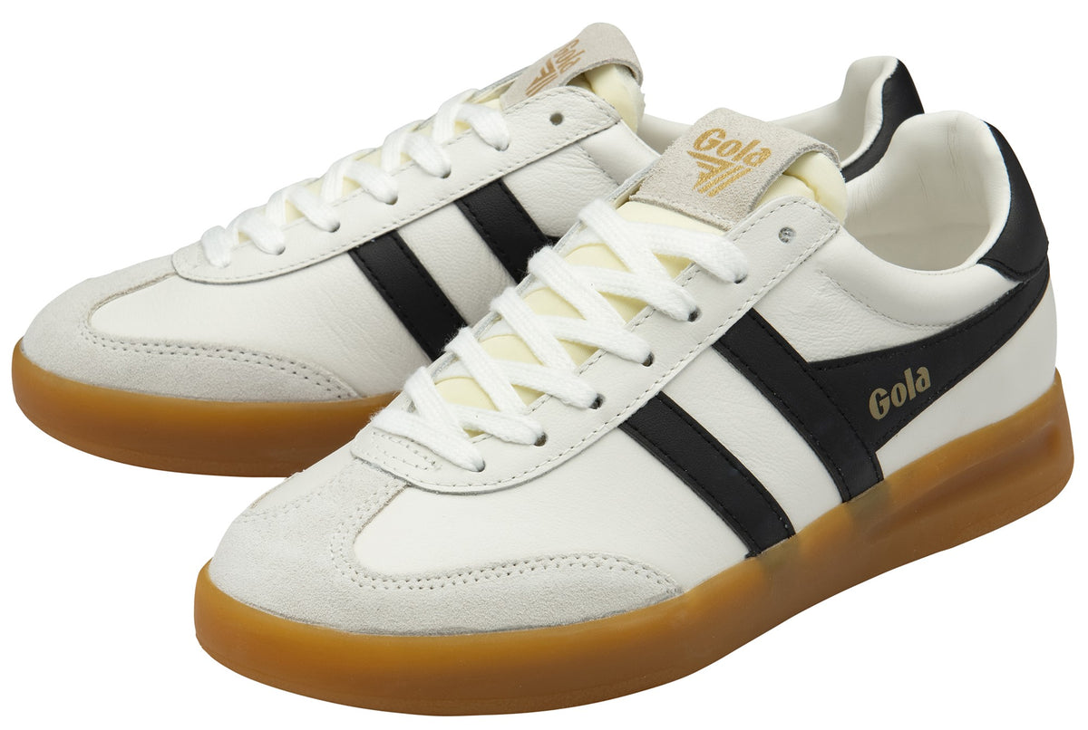 Low-top, white sneakers with black stripes and gum soles. Gola logo is visible on the tongue and side.