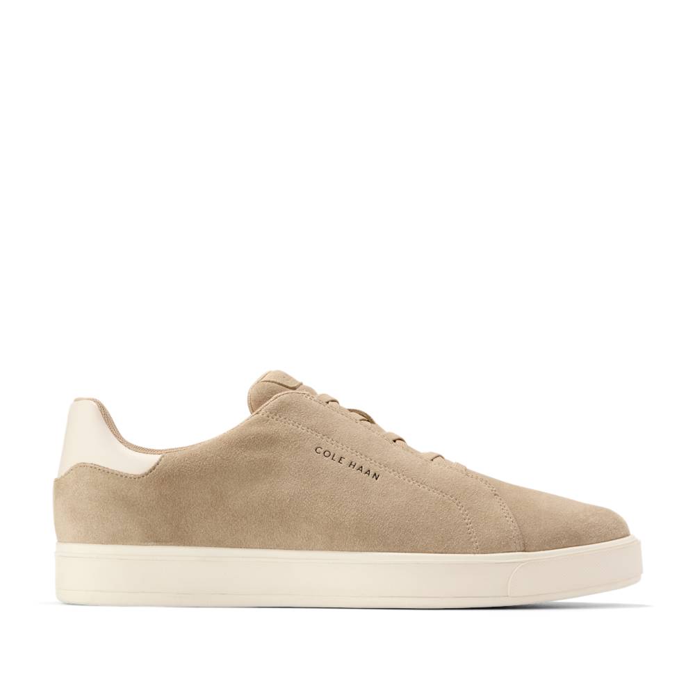Tan suede sneaker with white sole and heel.