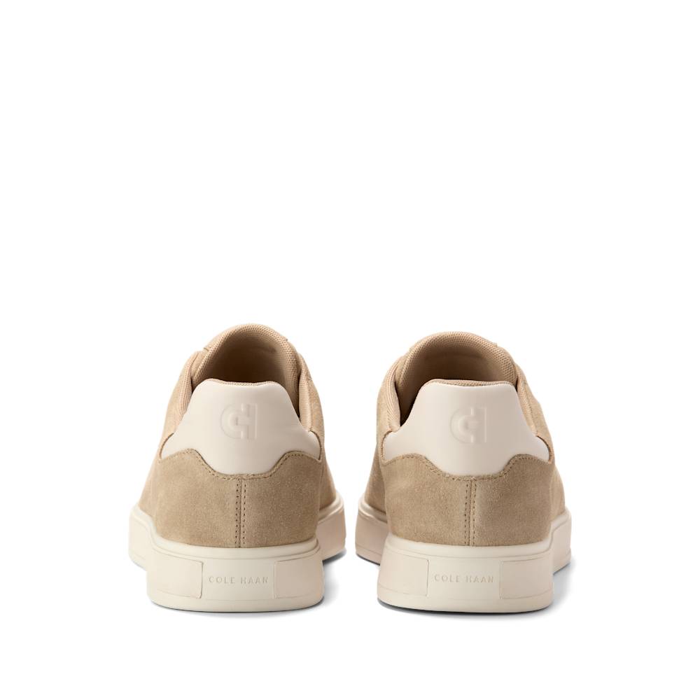 Rear view of tan suede sneakers with white soles and heel.