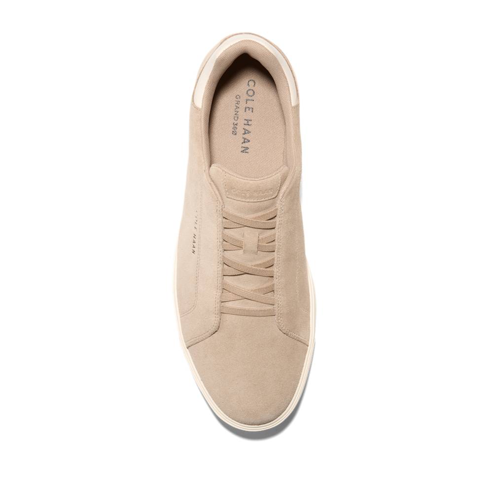 Top view of a tan suede sneaker with matching laces and a COLE HAAN GRAND.36Ø insole.