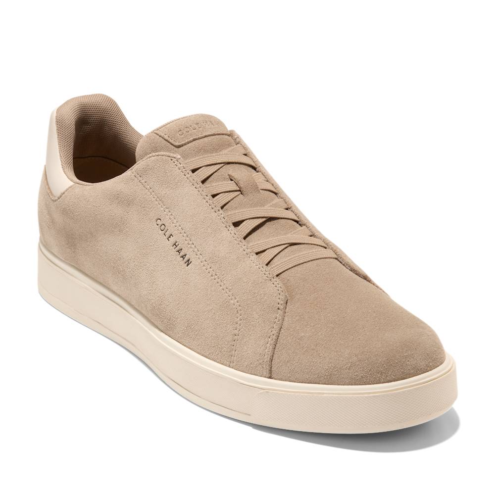 Beige suede sneaker with laces and COLE HAAN logo on the side.