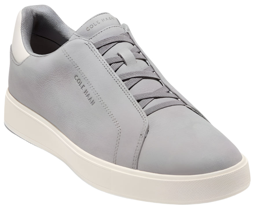 Low-top sneaker in light gray leather with white sole, gray laces, and COLE HAAN imprint.