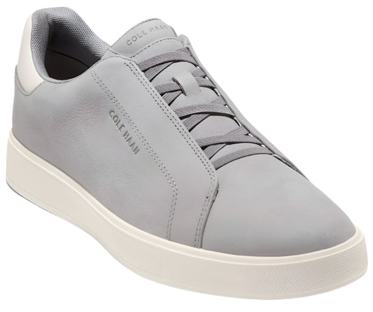 Low-top sneaker in light gray leather with white sole, gray laces, and COLE HAAN imprint.