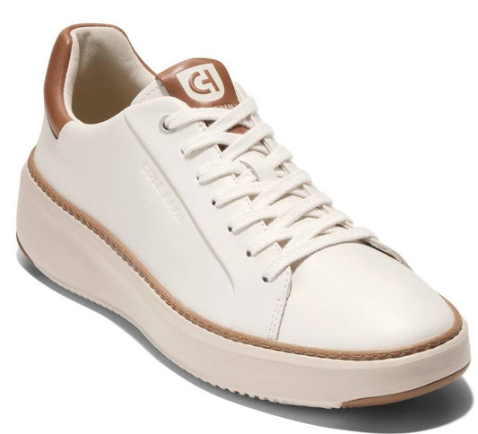 Off-white leather sneaker with white laces and brown accents on the heel and logo.