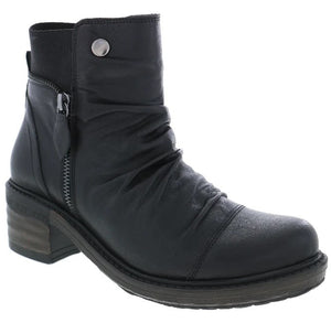 A black leather ankle boot with a rounded toe, a side zipper, a ruched shaft, a silver snap button detail near the top, and a stacked block heel with a dark, layered sole.