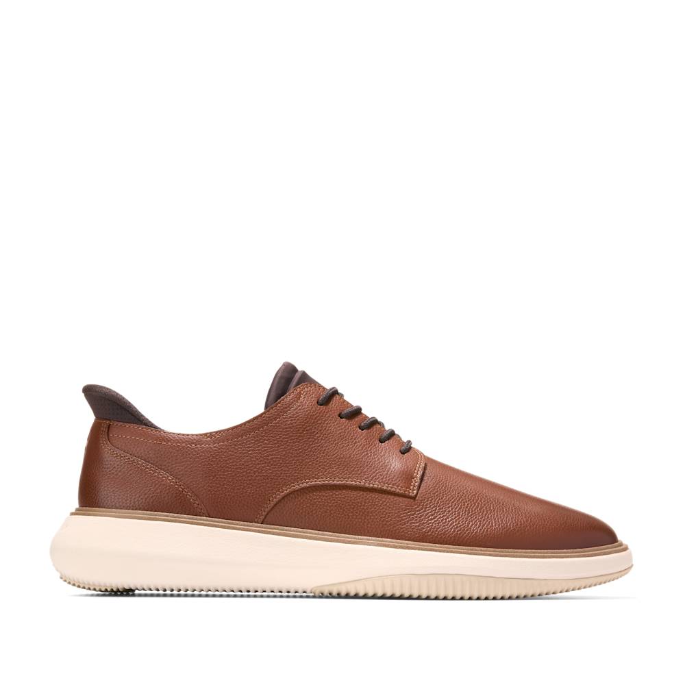 Brown leather casual shoe with a white sole and dark brown laces.