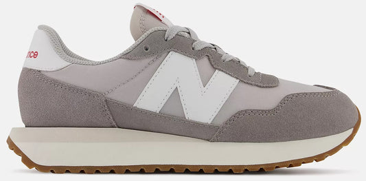 Grey and white sneaker with a brown sole.