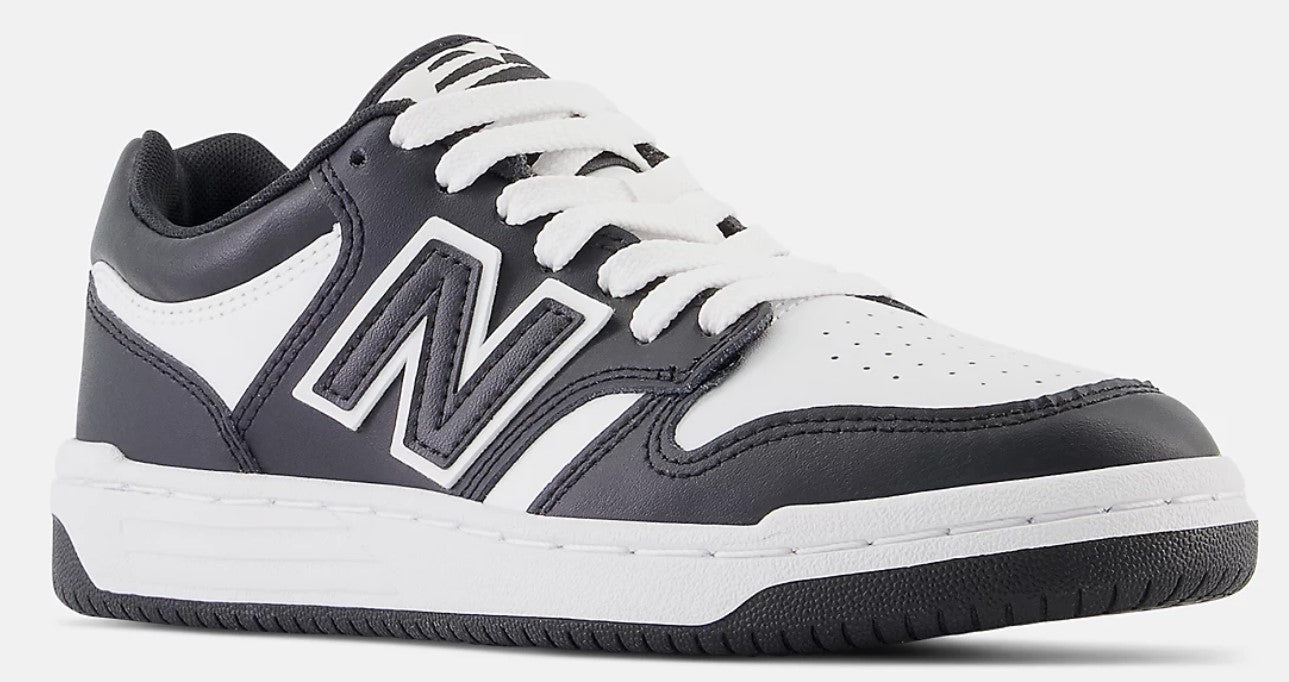 A low-top black and white New Balance sneaker with a large 'N' logo, white laces, and a white midsole.